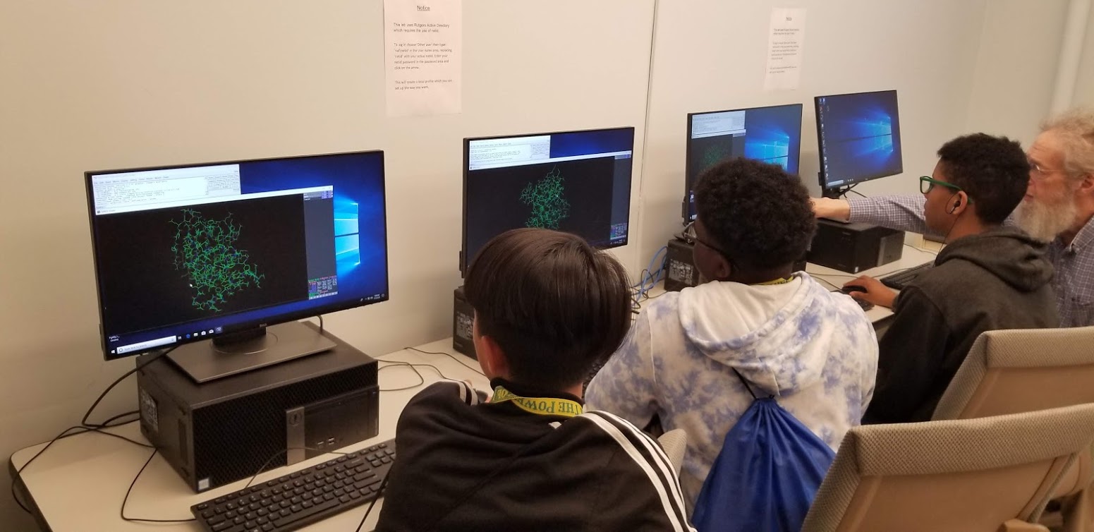 The student cohort examines structures of proteins in more detail using the software PyMOL with Dr. Peter Kahn and Dr. Ken McGuinness in a computer lab on Cook Campus.